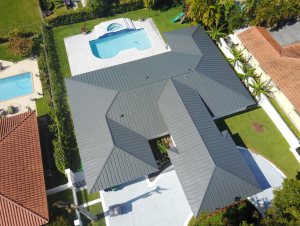 Aerial view of a standing seam metal roof showing hip geometry and multiple roof planes on a Florida residential home. 