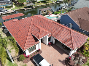 Aerial view of a Florida tile roof showing hip intersections and multiple roof planes on a waterfront residential home.